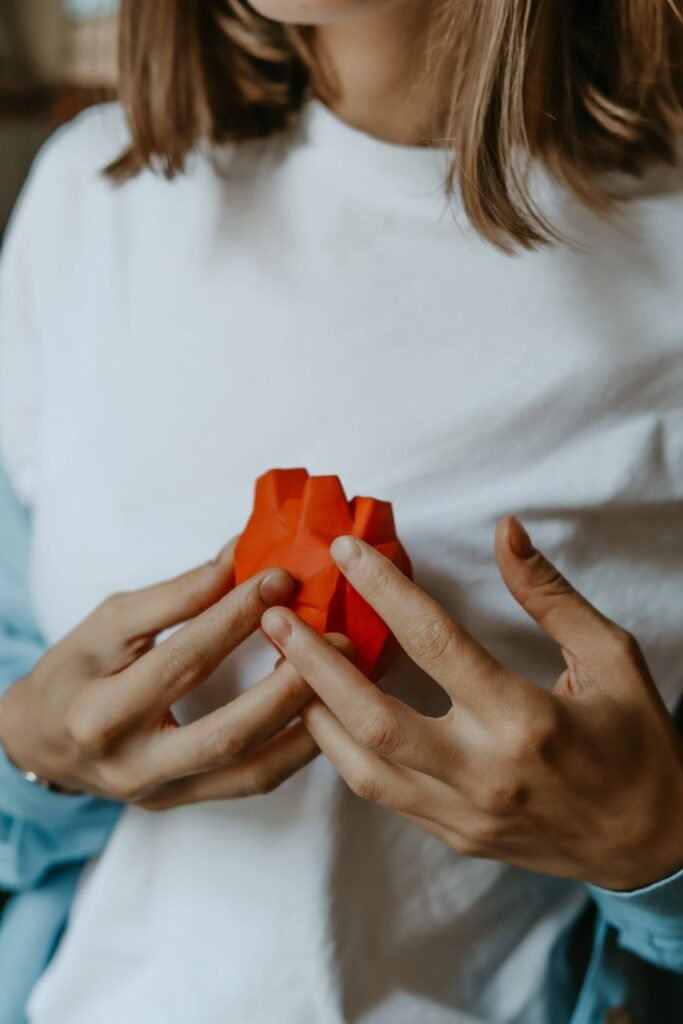 Hands gently holding a heart-shaped form, representing the release of the Heart-Wall®, the energetic wall of trapped emotions described in Emotion Code®.